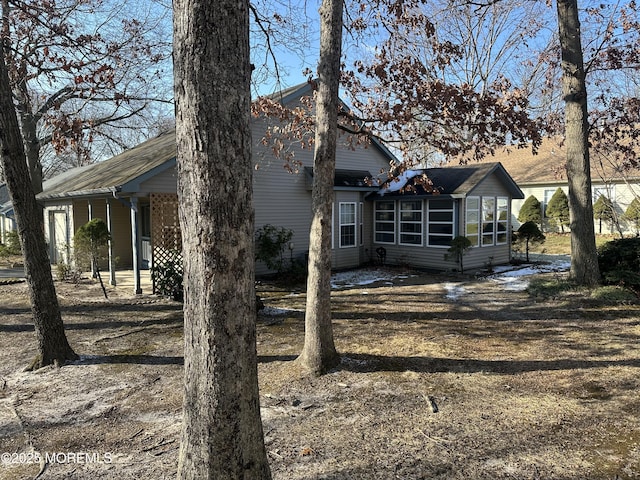 back of property with a sunroom