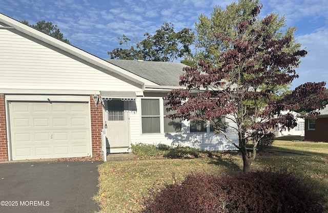 view of front facade with a garage and a front lawn