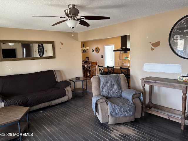 living room featuring wood finished floors, ceiling fan, and a textured ceiling