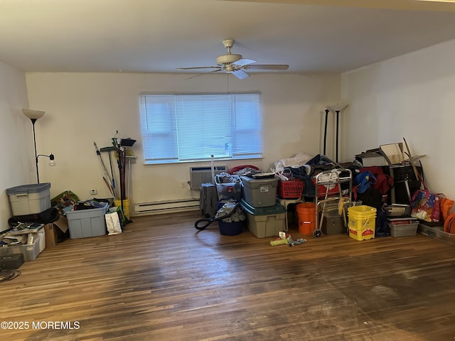 miscellaneous room with ceiling fan, wood-type flooring, a wall unit AC, and a baseboard heating unit