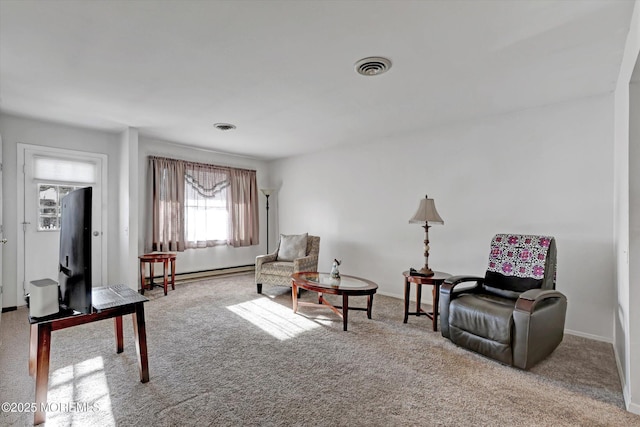 sitting room featuring light carpet and a baseboard heating unit