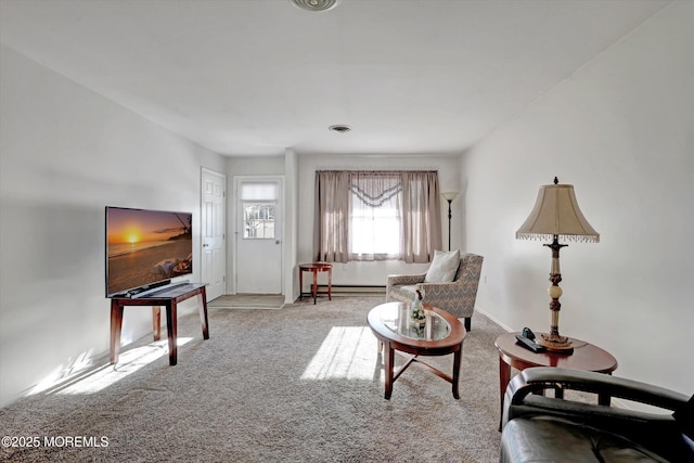 living area with light carpet and a baseboard radiator