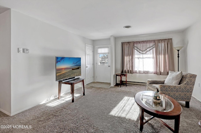 living room featuring light colored carpet and baseboard heating