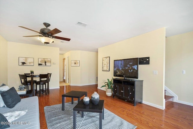 living room with ceiling fan and hardwood / wood-style flooring