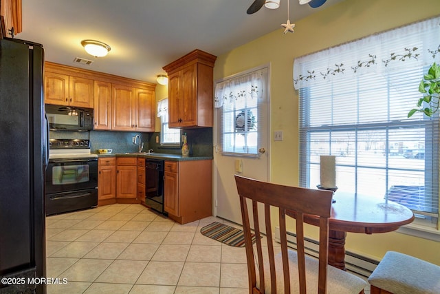 kitchen featuring a wealth of natural light, ceiling fan, tasteful backsplash, light tile patterned flooring, and black appliances