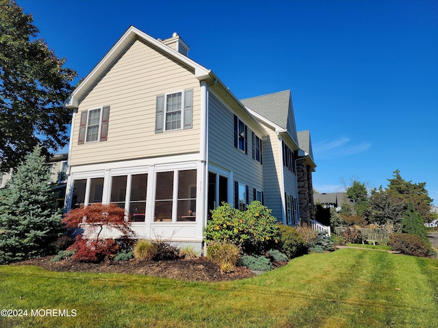 view of property exterior featuring a lawn