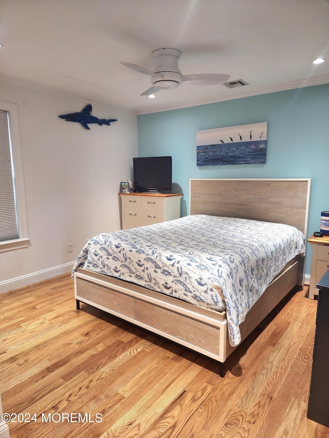 bedroom with ceiling fan, ornamental molding, and light hardwood / wood-style floors