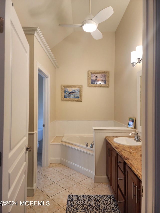 bathroom featuring ceiling fan, vanity, a bath, tile patterned floors, and toilet