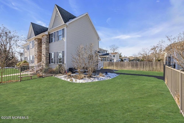 view of side of property with a lawn