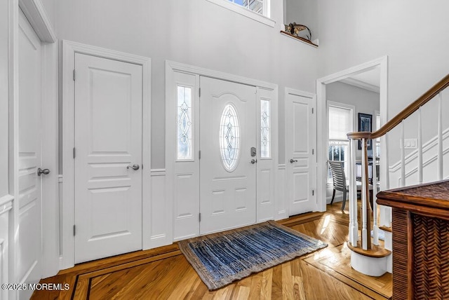 foyer entrance with plenty of natural light and hardwood / wood-style floors