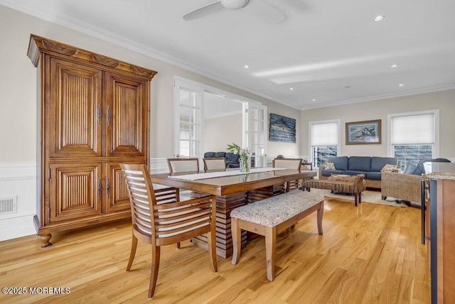 dining space featuring crown molding, ceiling fan, and light hardwood / wood-style flooring