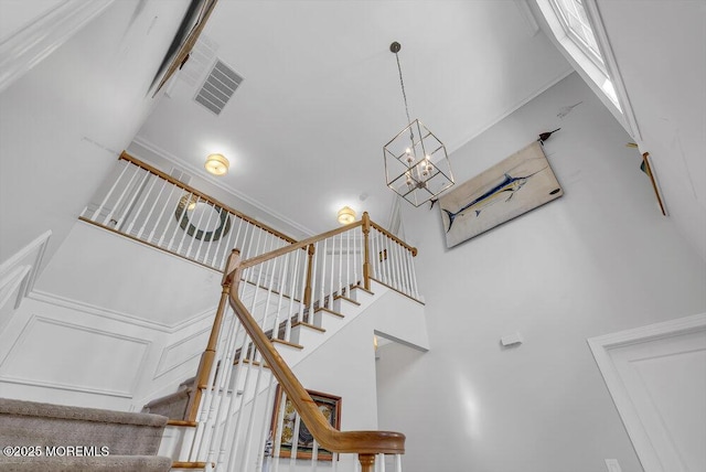 stairs with an inviting chandelier