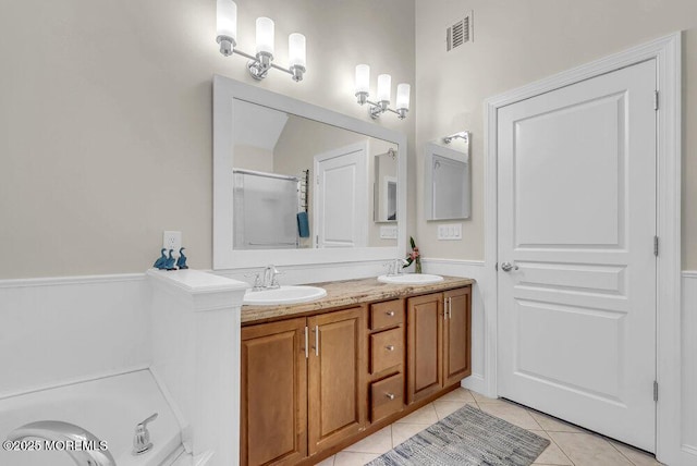 bathroom with vanity, tile patterned floors, and walk in shower