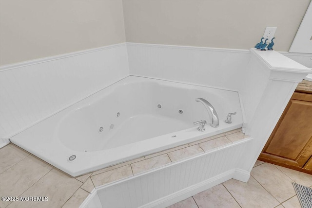 bathroom with a relaxing tiled tub and tile patterned flooring