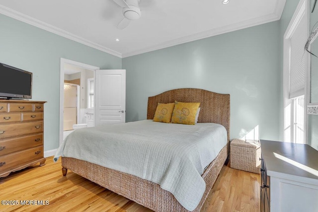 bedroom featuring ceiling fan, ensuite bath, crown molding, and light hardwood / wood-style flooring