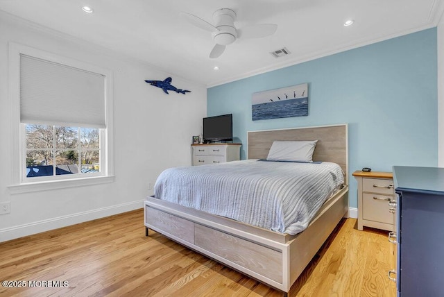 bedroom with crown molding, light hardwood / wood-style flooring, and ceiling fan