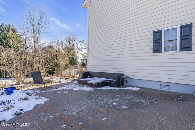 view of snowy exterior featuring a patio