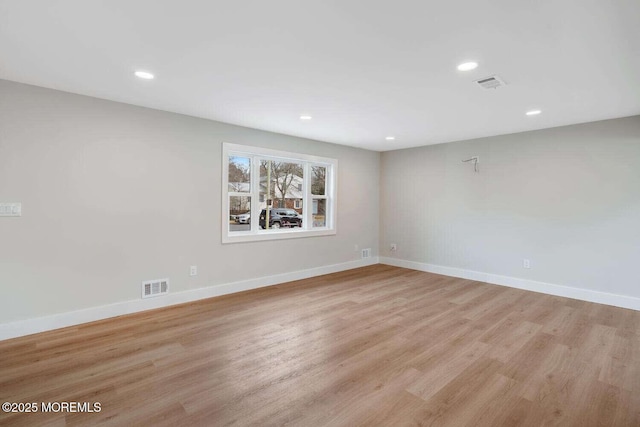 empty room with light hardwood / wood-style flooring