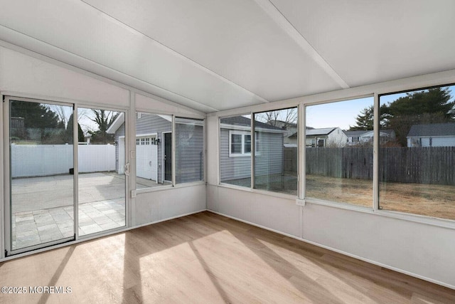 unfurnished sunroom with a wealth of natural light and vaulted ceiling