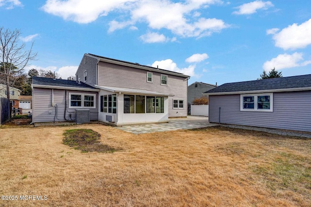 rear view of house featuring a yard, a patio, and central AC