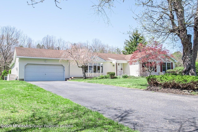 ranch-style home with a garage and a front yard