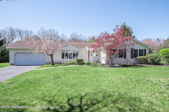 view of front of property featuring a garage and a front lawn