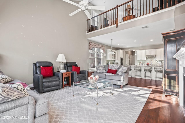 living room featuring ceiling fan, sink, and light hardwood / wood-style flooring