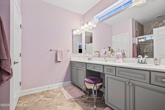 bathroom featuring a shower with door and vanity