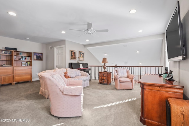 living room featuring vaulted ceiling, light colored carpet, and ceiling fan