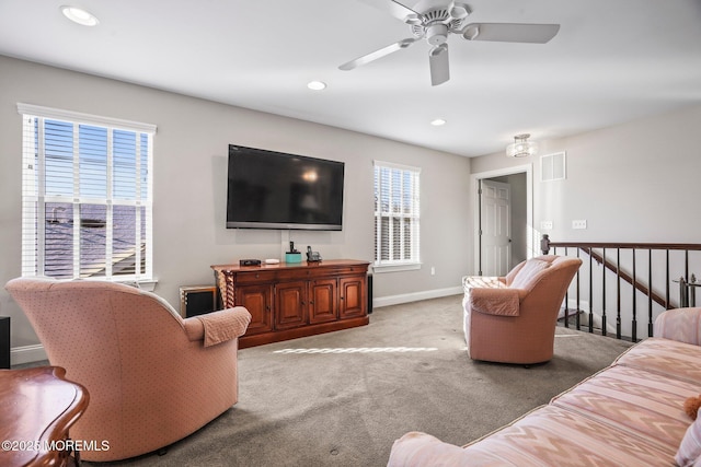 carpeted living room featuring ceiling fan