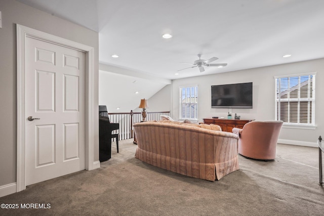 living room with ceiling fan and carpet