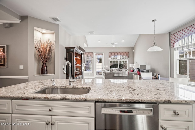 kitchen with white cabinetry, stainless steel dishwasher, sink, and light stone counters