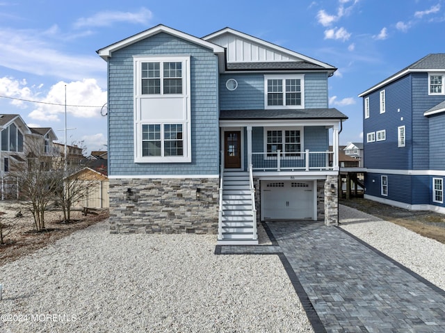 front facade with a porch and a garage