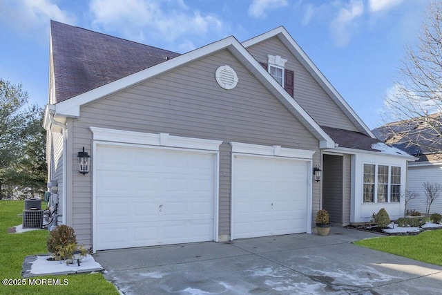 view of front facade with cooling unit and a garage