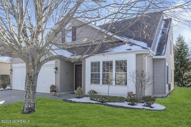 view of front of house with a garage and a front lawn