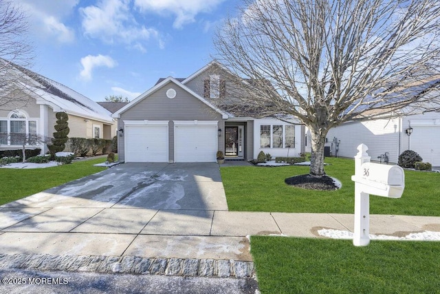 view of property featuring a garage and a front lawn