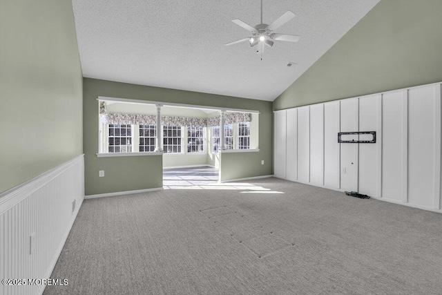 empty room with ceiling fan, light colored carpet, and a textured ceiling