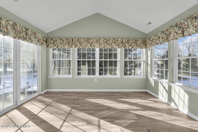 unfurnished sunroom with vaulted ceiling