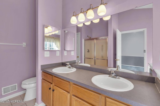 bathroom with vanity, tile patterned floors, toilet, and walk in shower