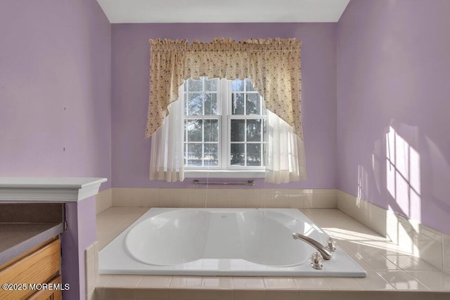 bathroom featuring vanity and a relaxing tiled tub