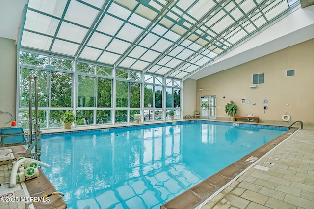 view of pool featuring glass enclosure