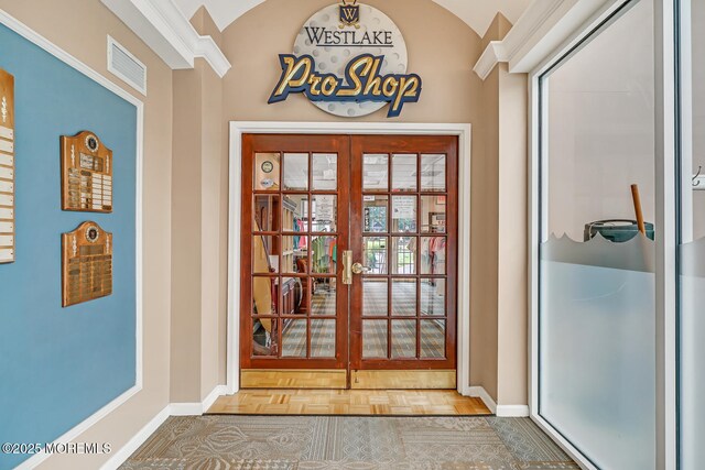 doorway to outside featuring lofted ceiling, parquet flooring, and french doors