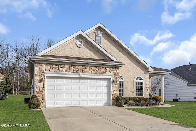 front of property featuring a garage, a front yard, and central air condition unit