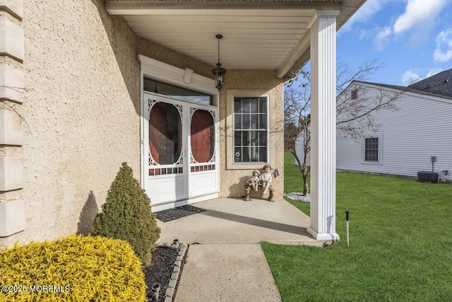 doorway to property with a lawn