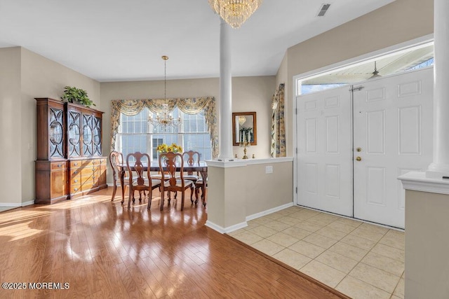 foyer featuring an inviting chandelier and light hardwood / wood-style flooring