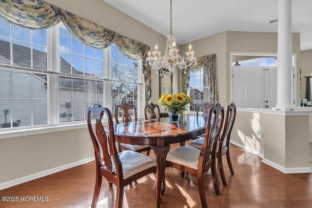 dining area featuring a notable chandelier and dark wood-type flooring