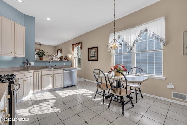 dining area with sink, a wealth of natural light, and light tile patterned flooring