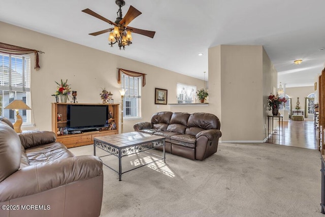 carpeted living room with ceiling fan