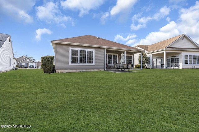 back of property with a patio area and a lawn