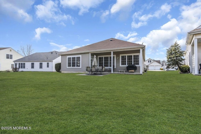 back of house with a lawn and a patio area